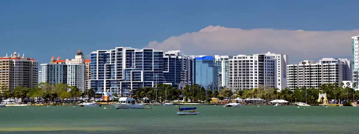 High-rise towers along the bayfront in downtown Sarasota, Florida, with boats moored in the bay